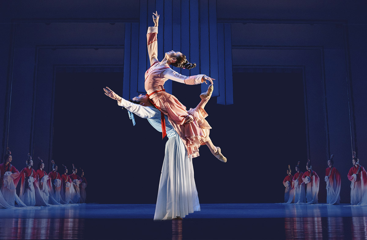 Male and female dancer on stage in a pose.