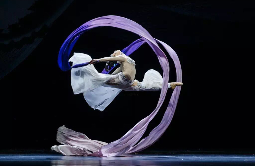 Dancer leaping with ribbons