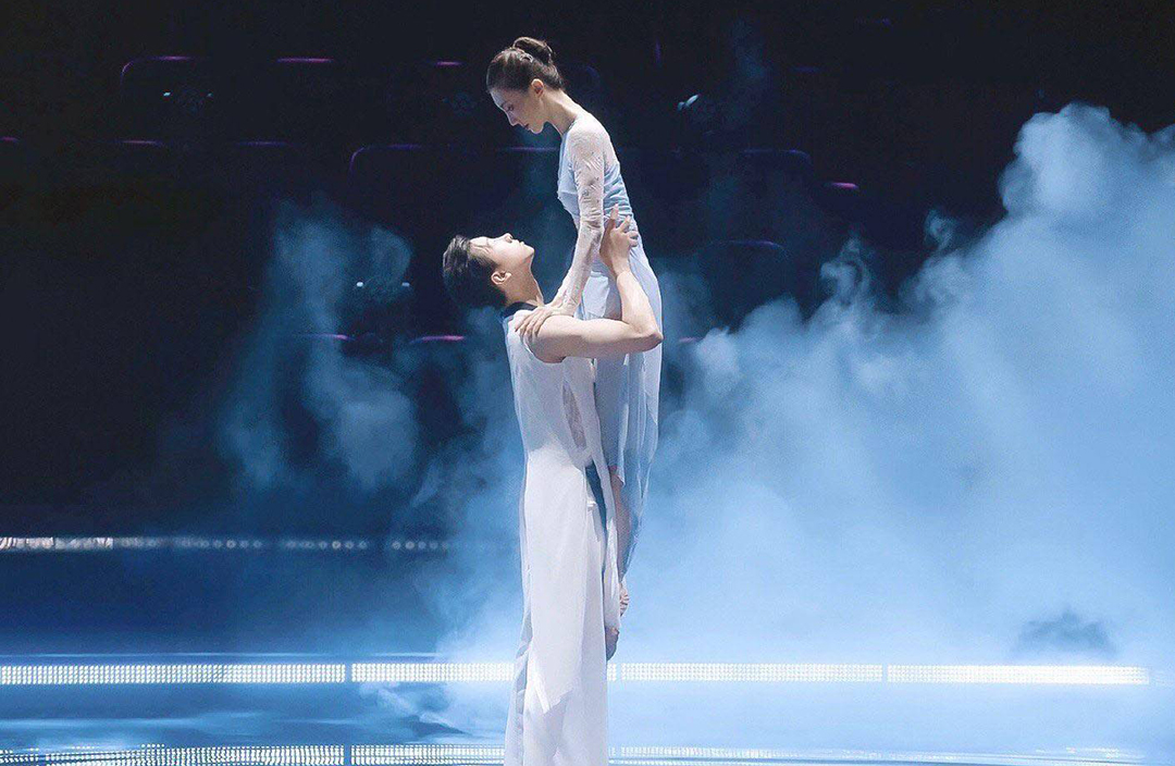 Male dancer lifting female dancer.